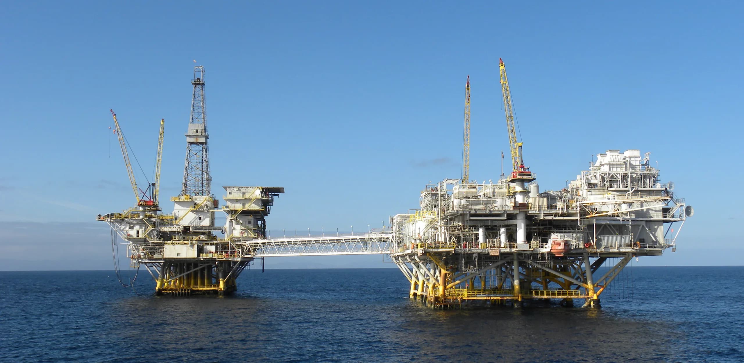 Two connected offshore production platforms at sea