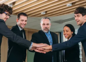 Small group of executives aligned in agreement during a strategic leadership discussion
