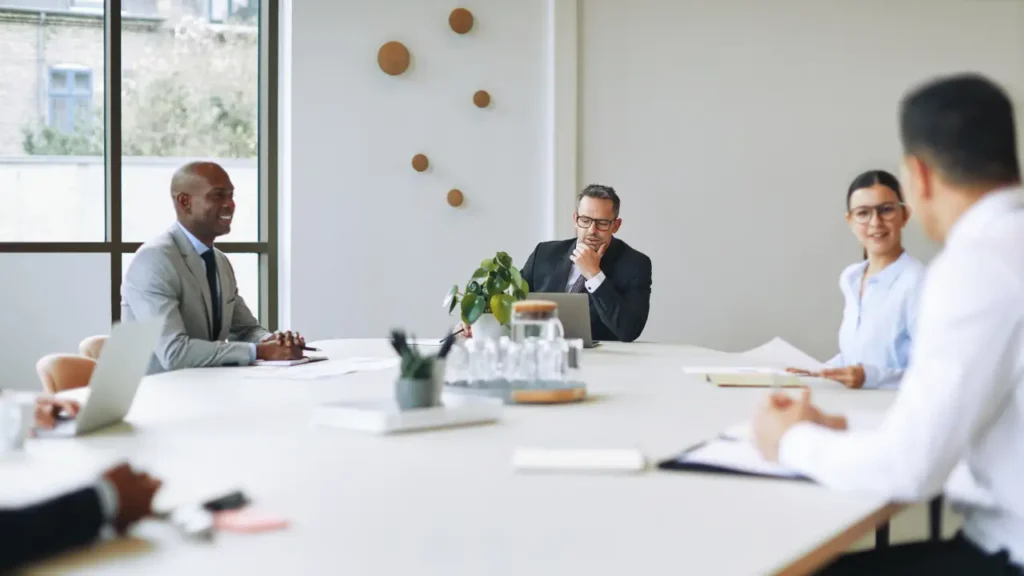 Executive leadership team meeting in a boardroom to discuss governance and strategic decisions