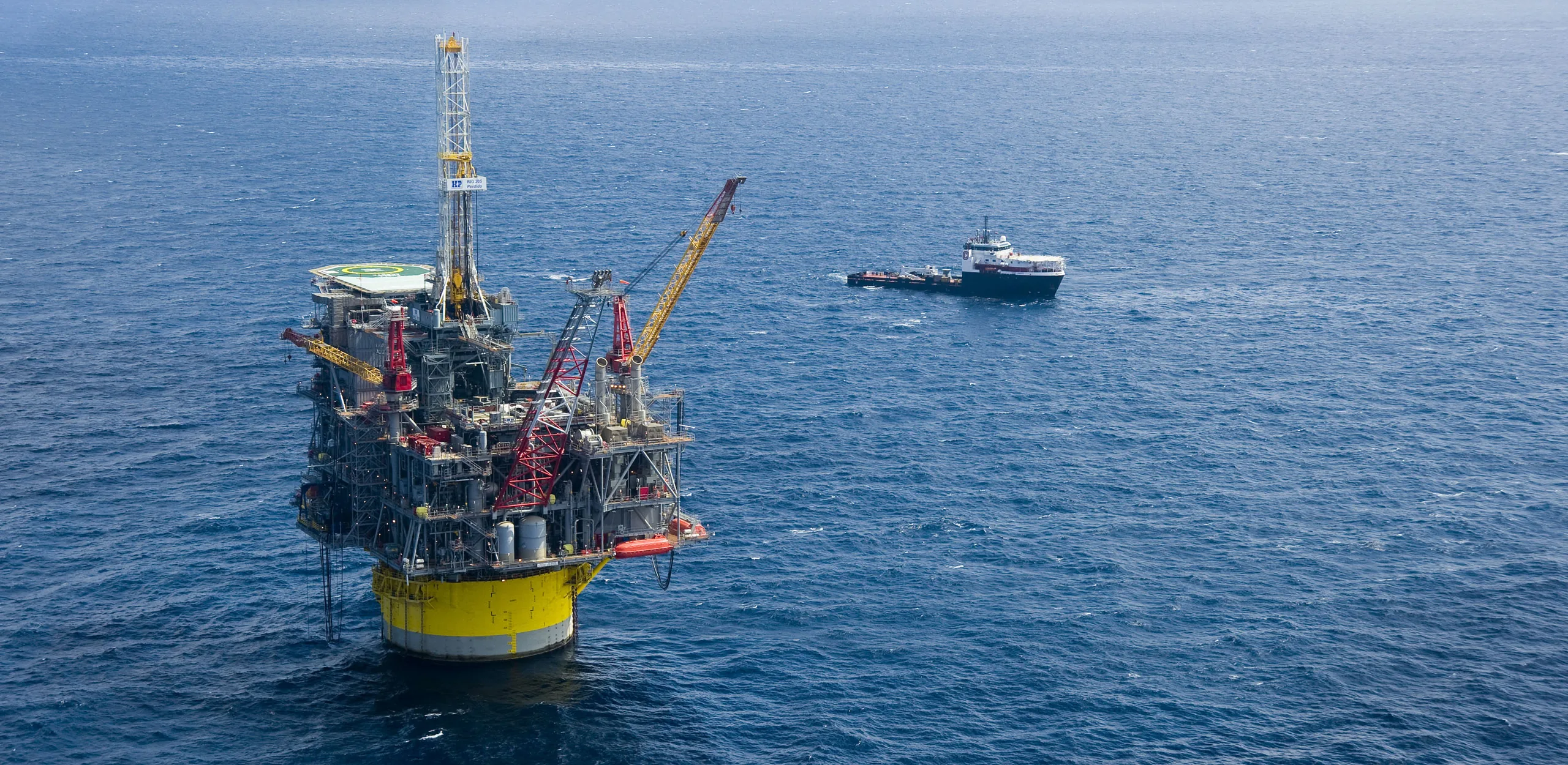 Deepwater production platform with a supply vessel alongside in the Gulf of Mexico
